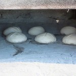 bread cooking in stone oven